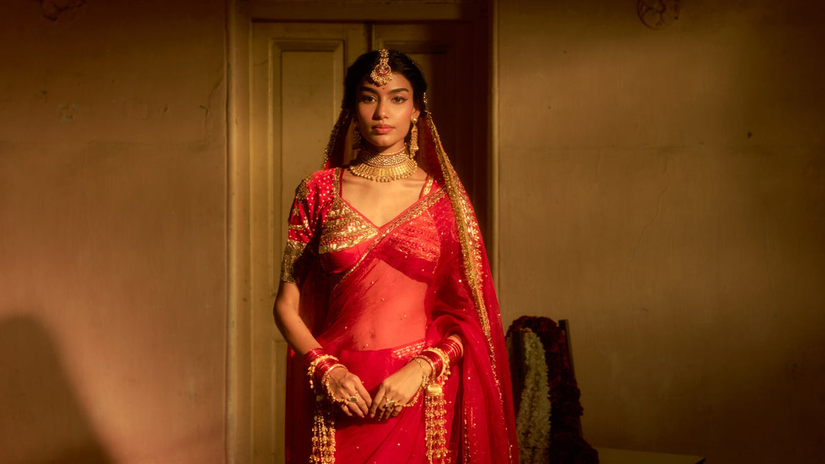 Bride in a red hand-worked Gota Patti lehenga and Aangi by House of Baisa, Jaipur