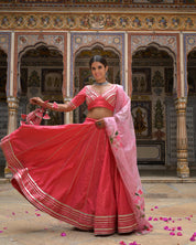 Draping of net dupatta in pink lehenga outfit