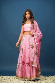 Full view of woman twirling in pink lehenga set for mehendi or wedding function

