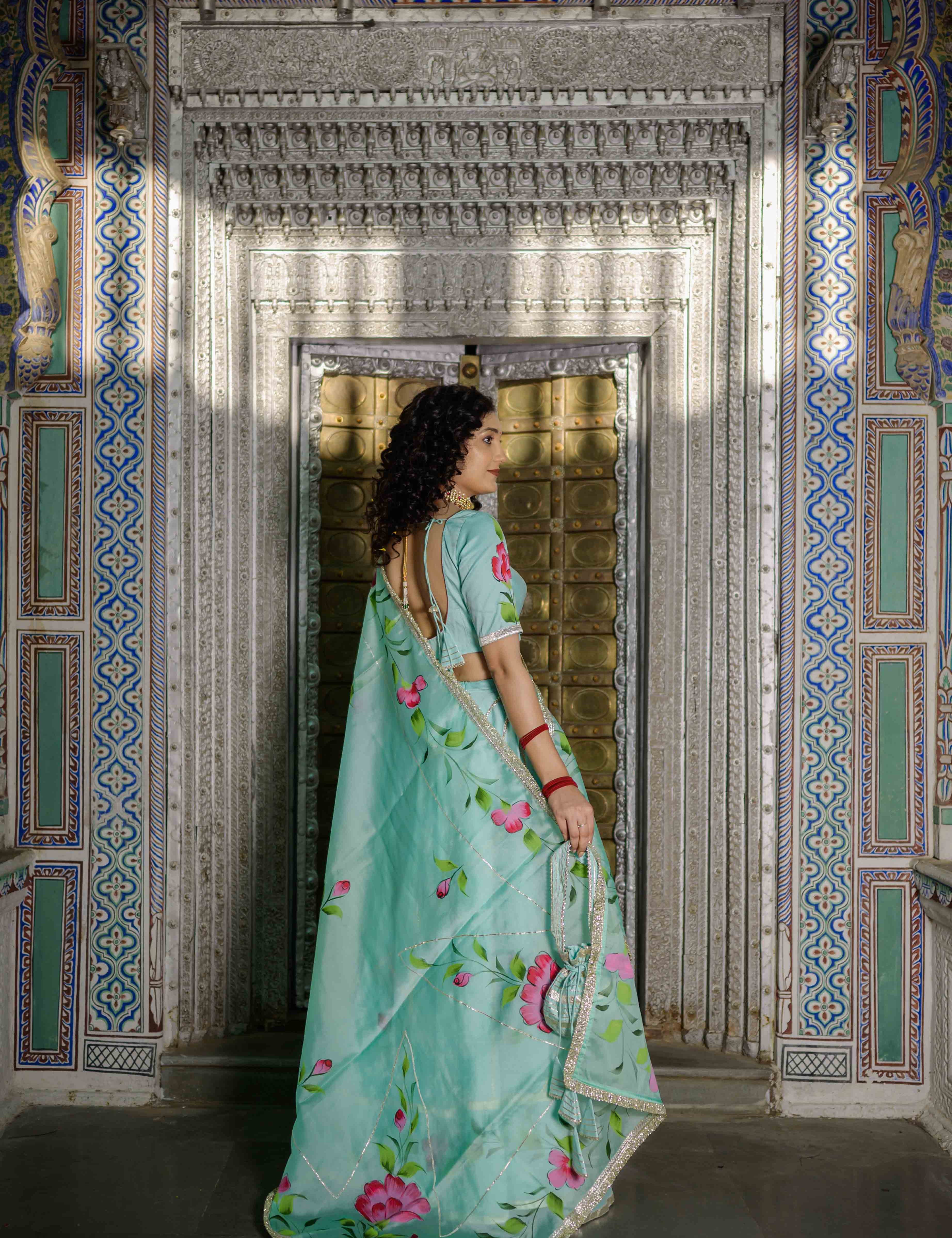 Green lehenga set with pastel pink floral prints and silver gota work

