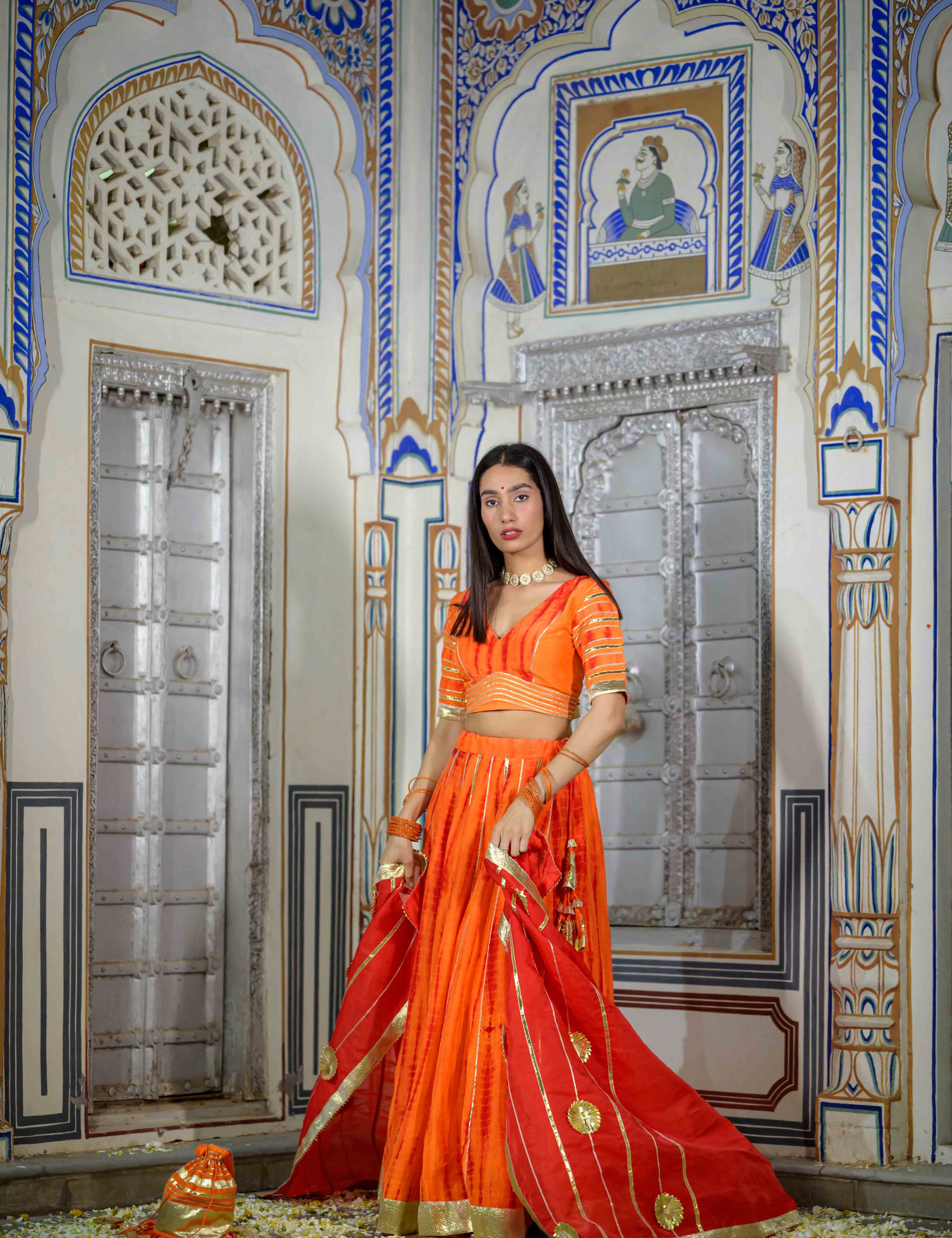 House of Baisa orange lehenga worn by model for wedding event

