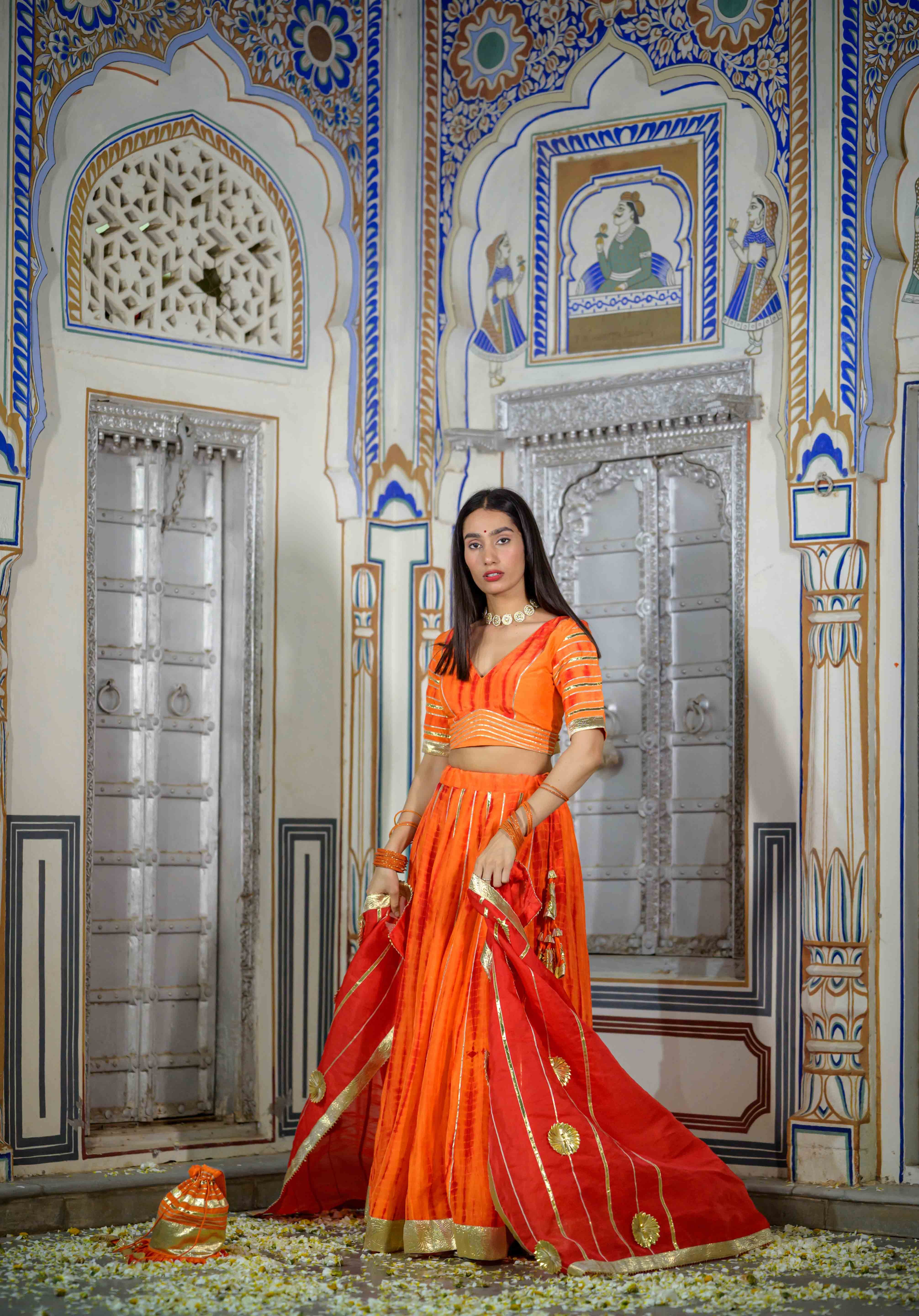 House of Baisa orange lehenga worn by model for wedding event

