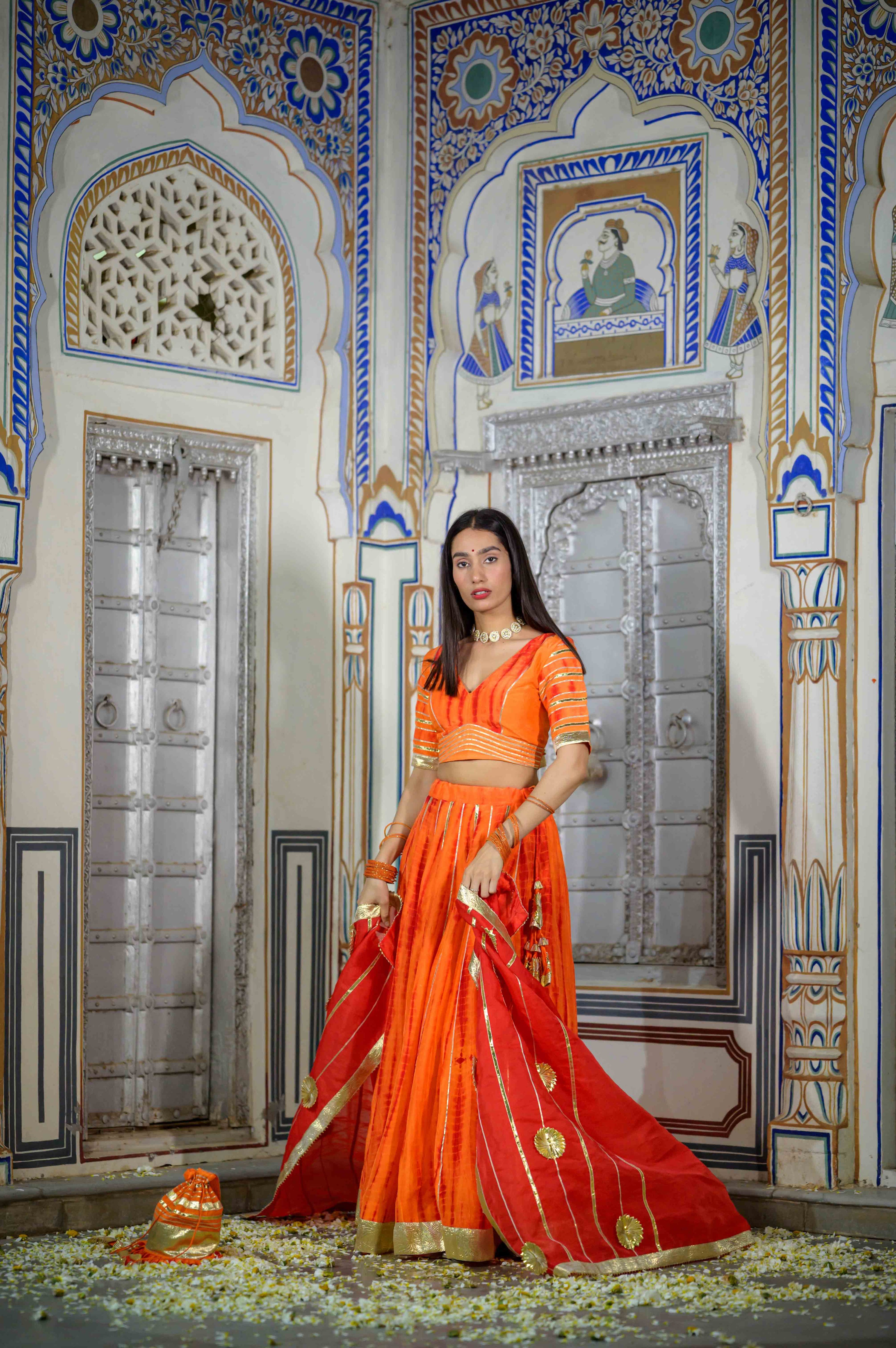 House of Baisa orange lehenga worn by model for wedding event

