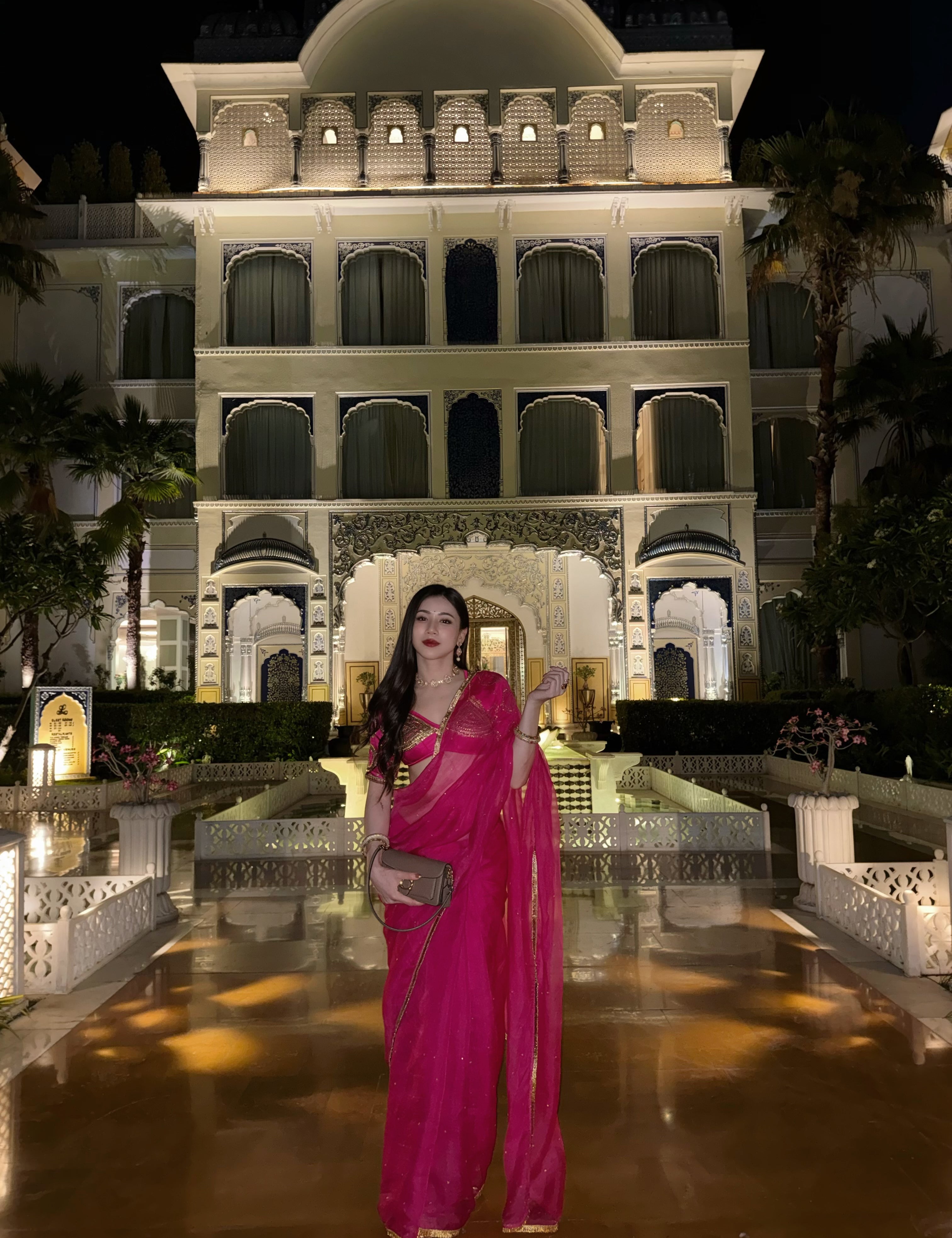 A woman wearing a bright magenta pink saree Kalyani aangi blouse Saree Set by House of Baisa