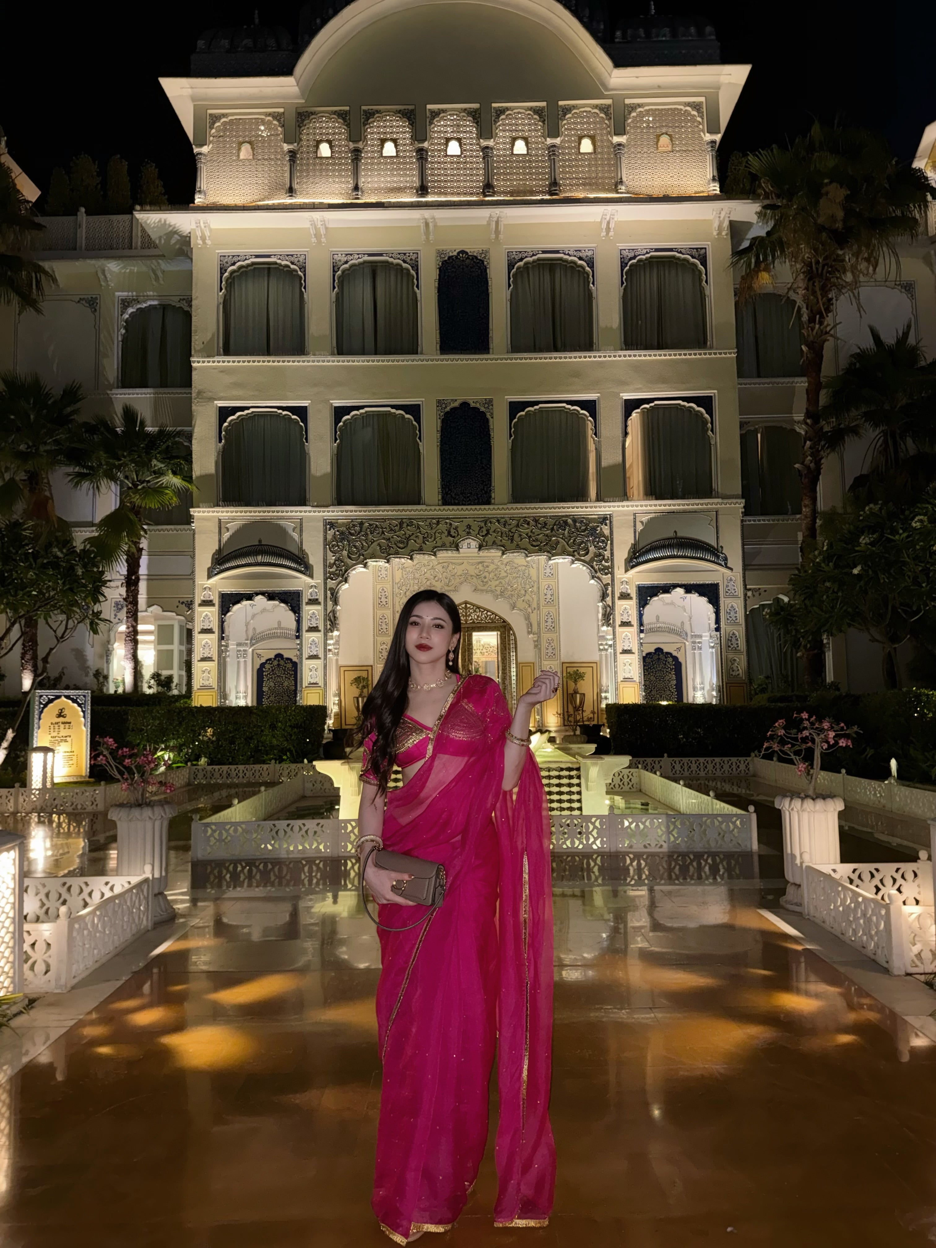A woman wearing a bright magenta pink saree Kalyani aangi blouse Saree Set by House of Baisa