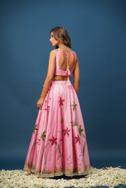 Mandakini pink lehenga flatlay showing satin texture and floral print details

