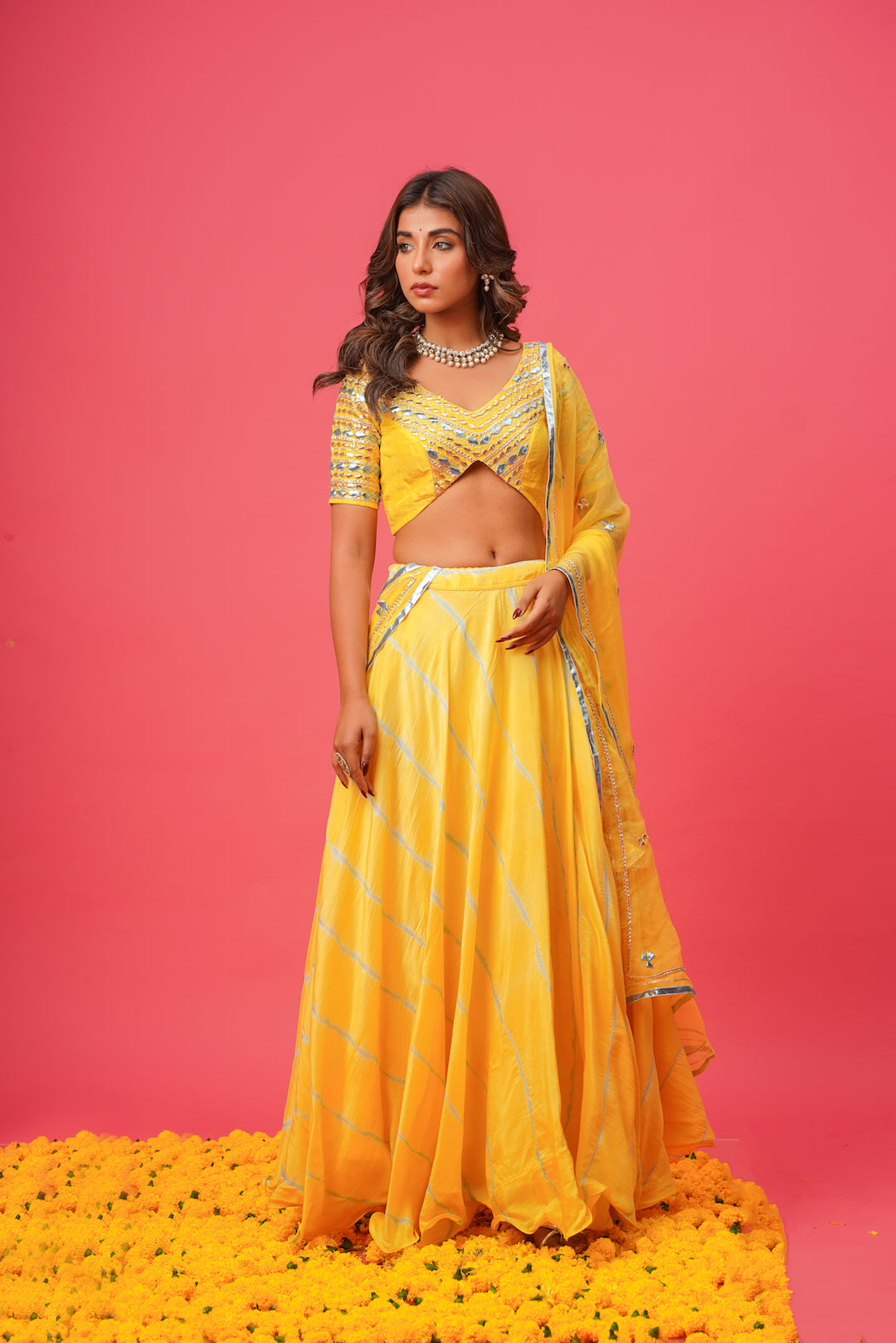 Model wearing yellow lehenga for haldi or wedding ceremony