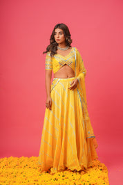 Model wearing yellow lehenga for haldi or wedding ceremony