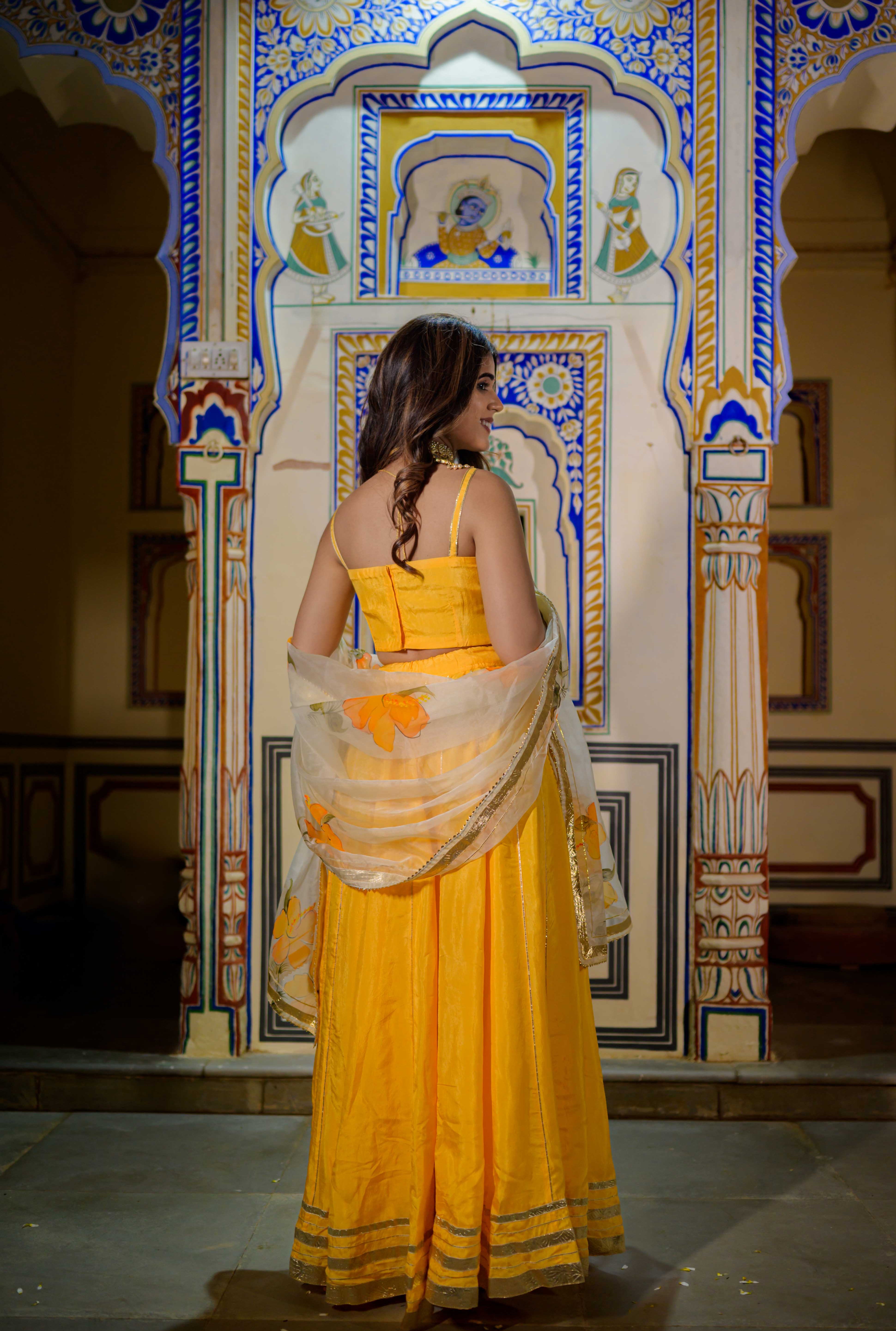 Orange lehenga outfit styled for haldi or mehendi celebration

