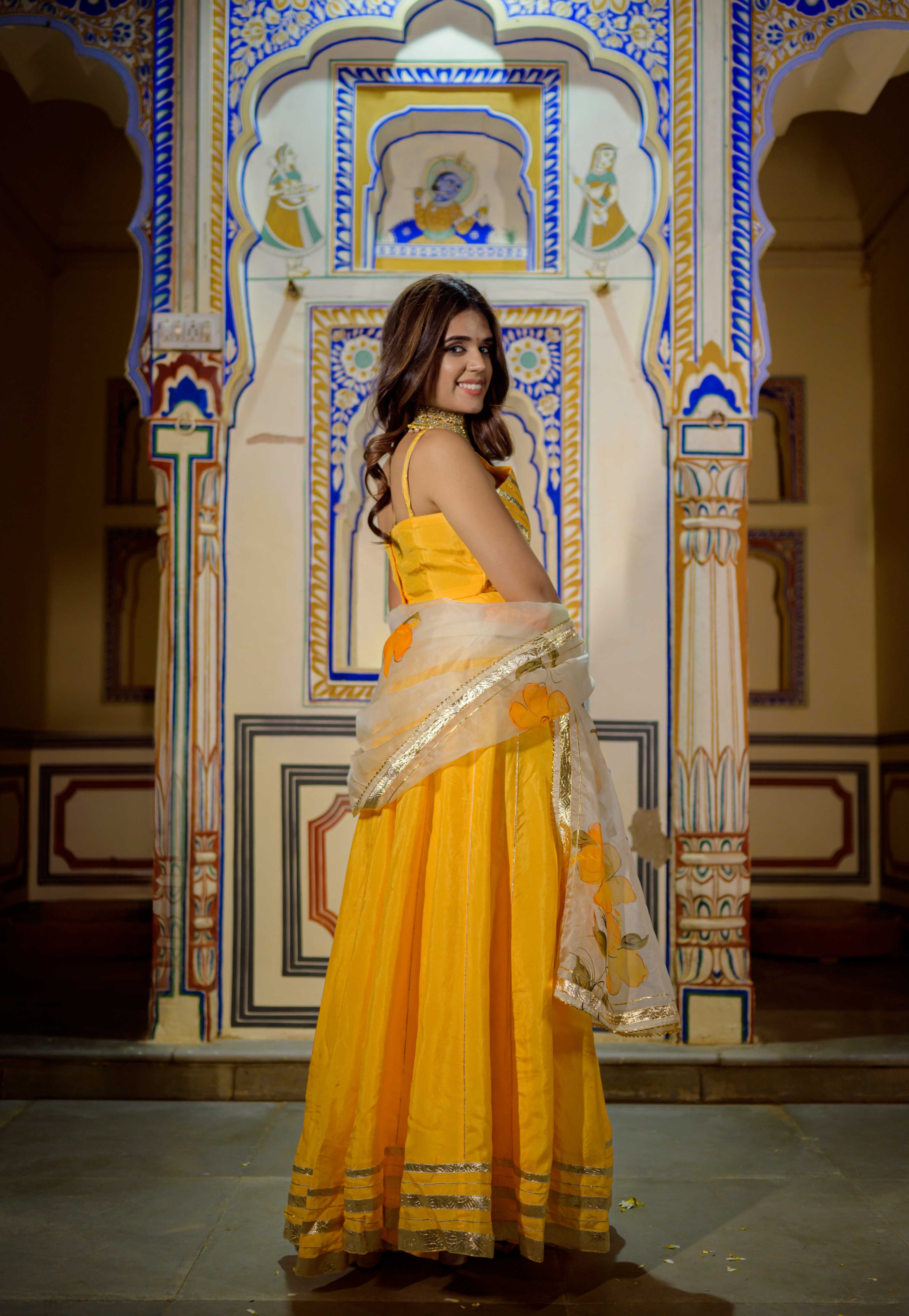 Orange lehenga outfit styled for haldi or mehendi celebration

