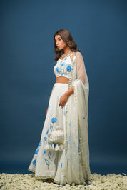 Full lehenga set laid out with blouse, skirt, and dupatta
