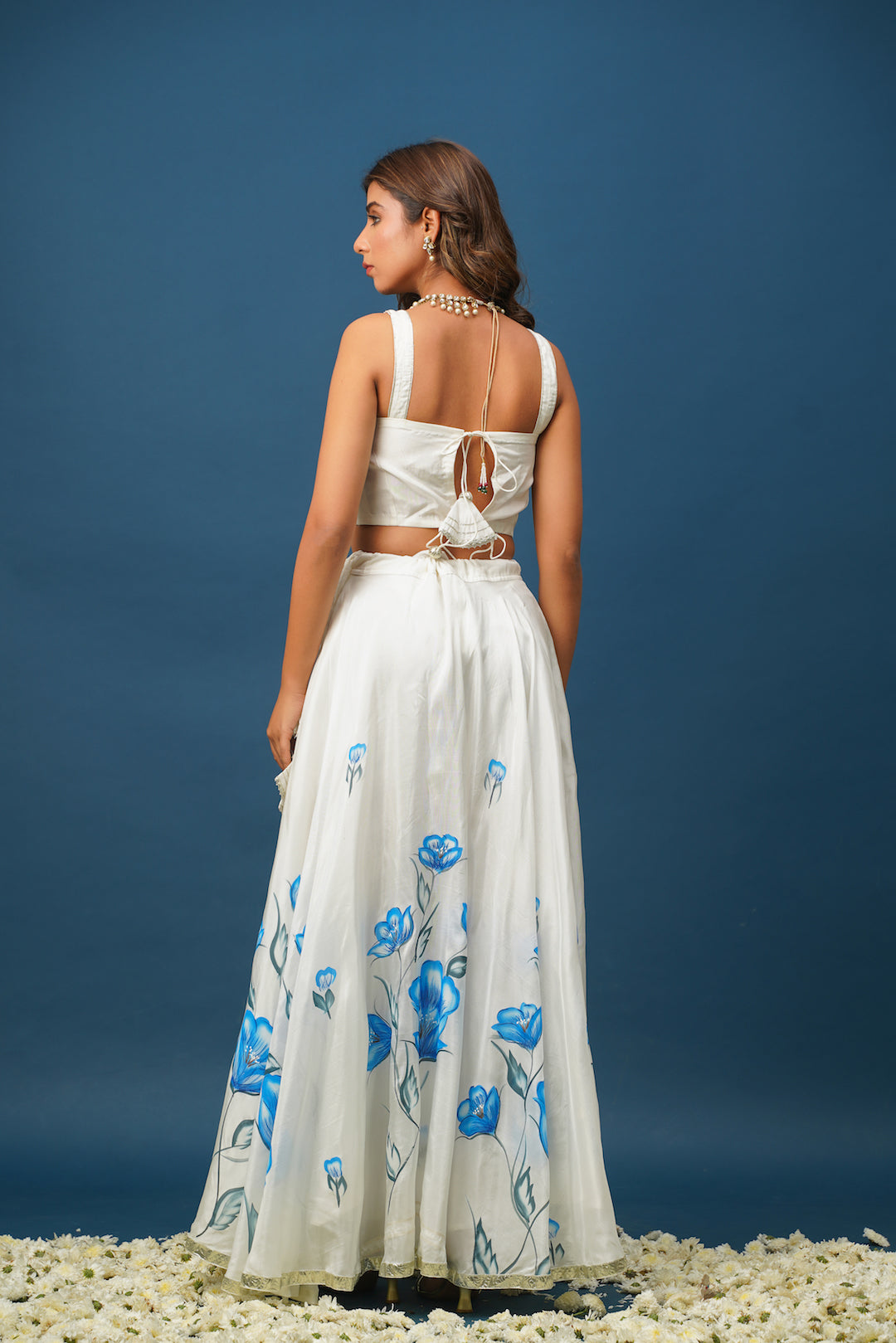 Full lehenga set laid out with blouse, skirt, and dupatta back si