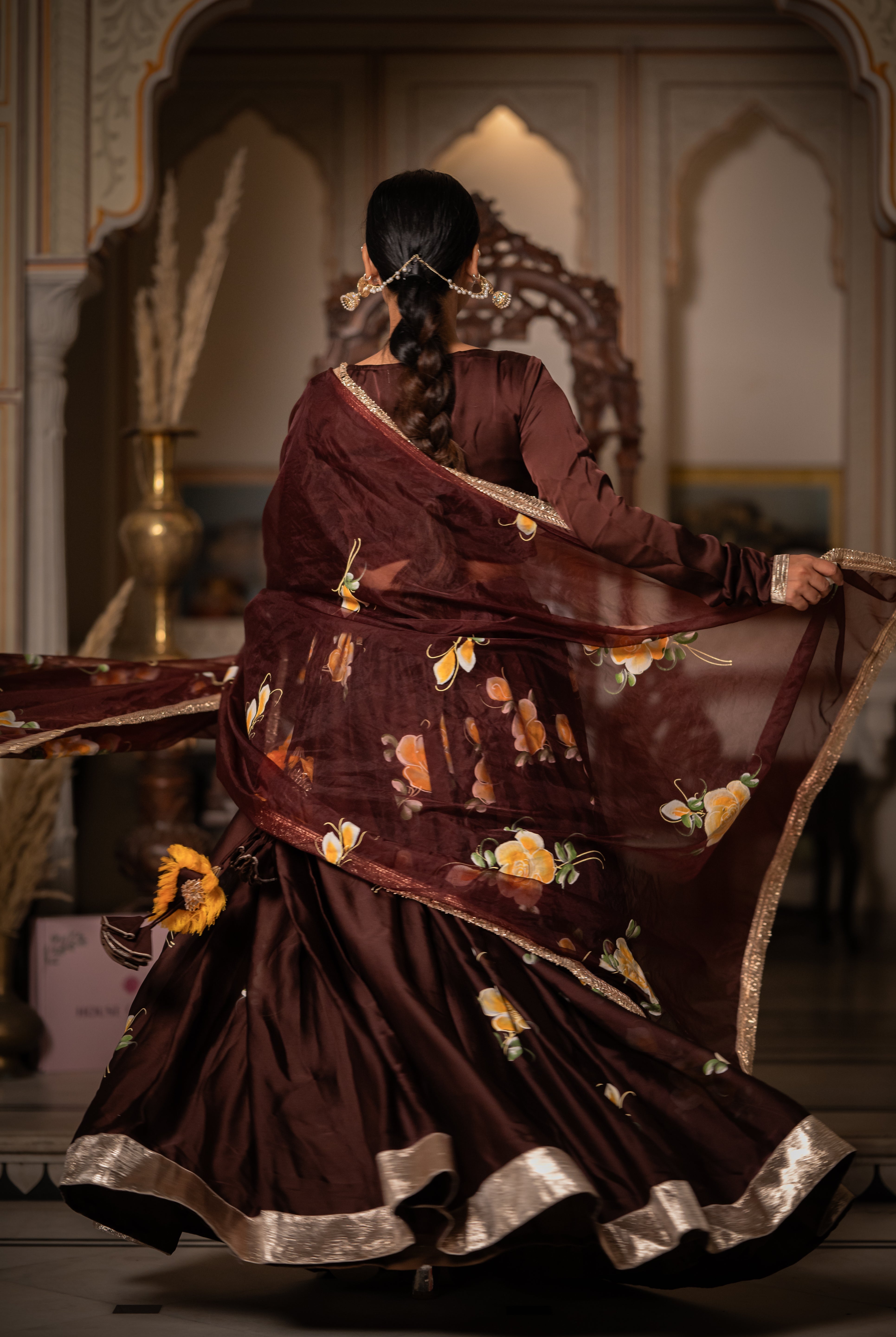 Full view of brown lehenga choli with handcrafted floral detailing
