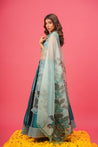 Festive look in teal lehenga paired with pearl jewelry	