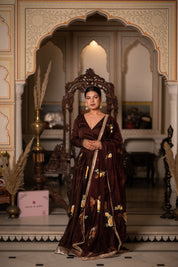 Close-up of floral artwork on brown satin lehenga blouse