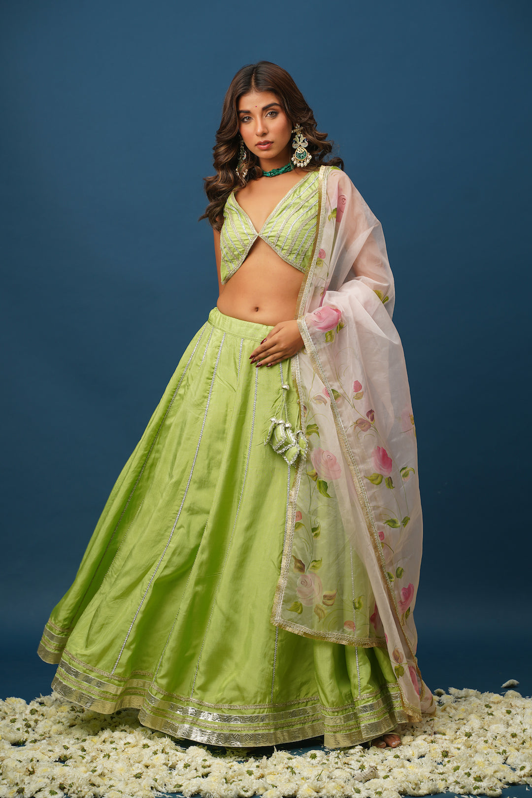 Back view of Maya green lehenga showing blouse design and dupatta drape
