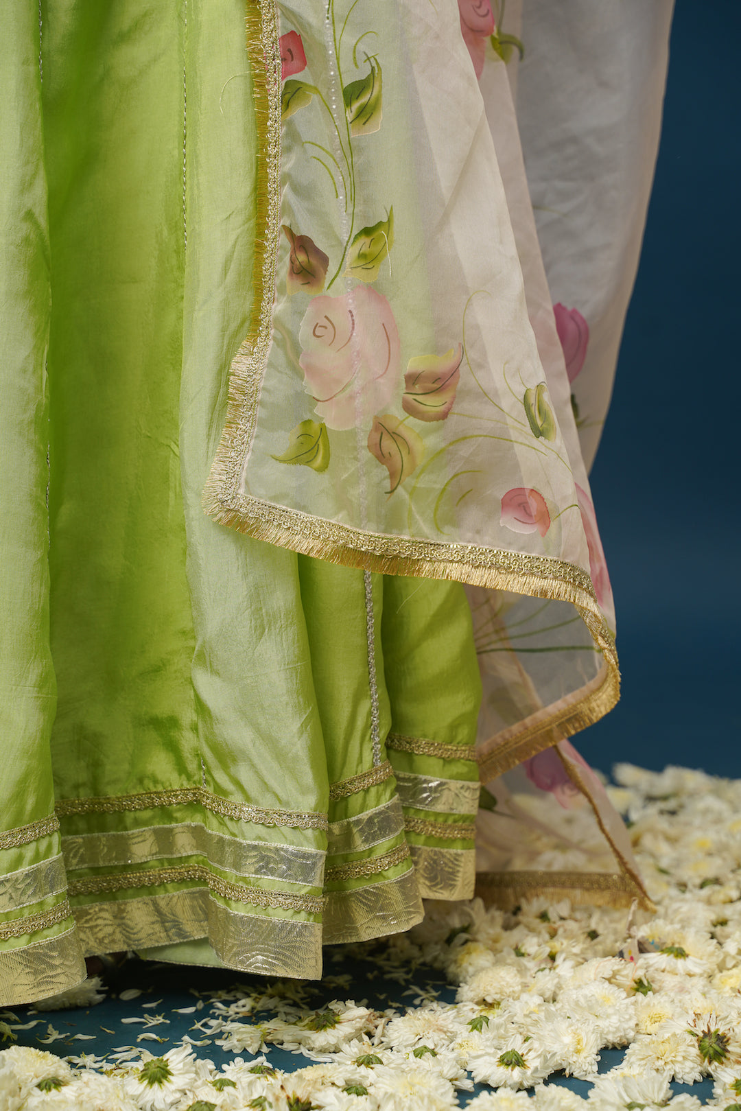 Elegant festive look in Maya green lehenga set with minimal jewelry
