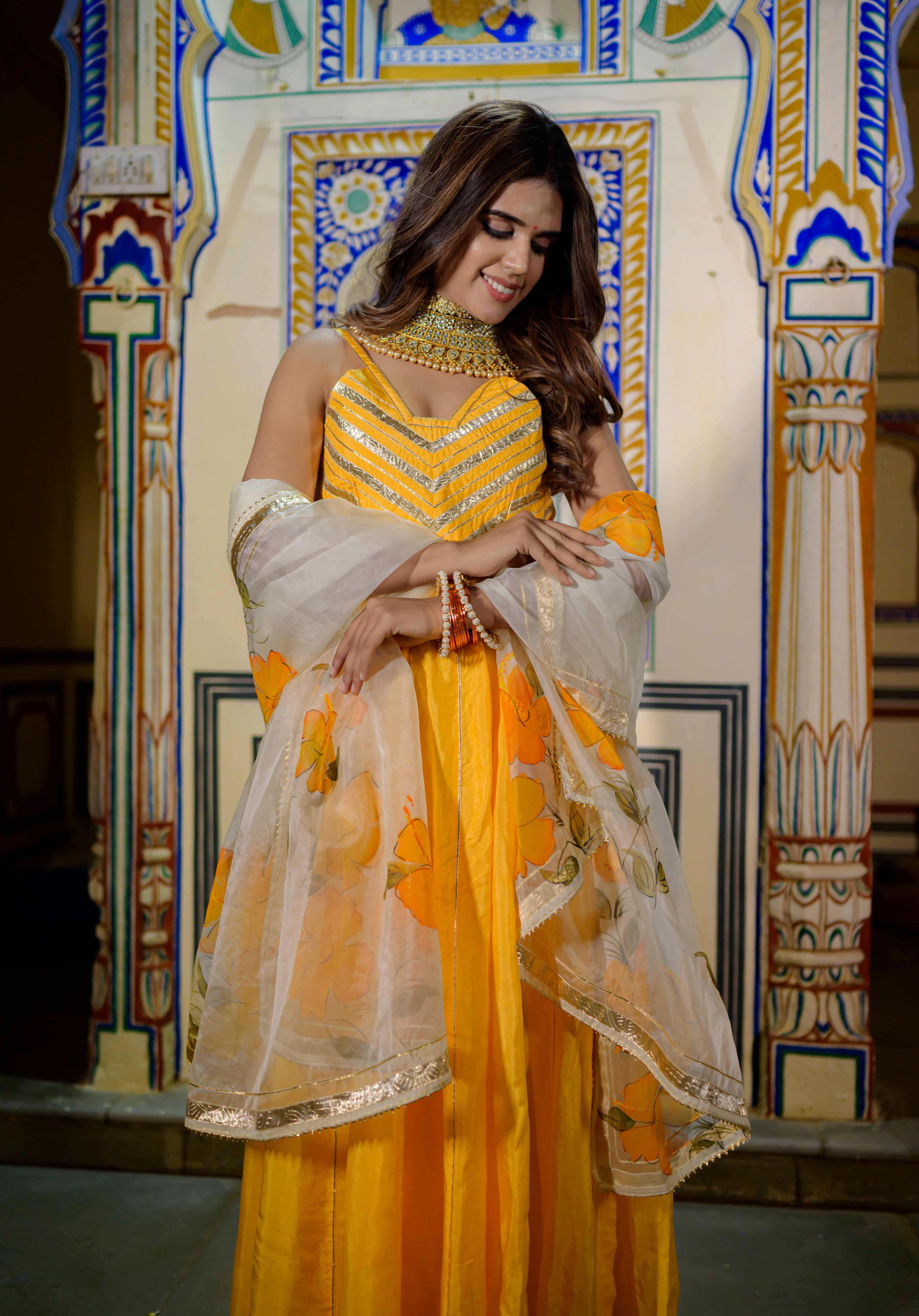 Close-up of hand-applied gota detailing on orange blouse and dupatta
