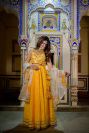 Model wearing vibrant orange lehenga for festive occasions

