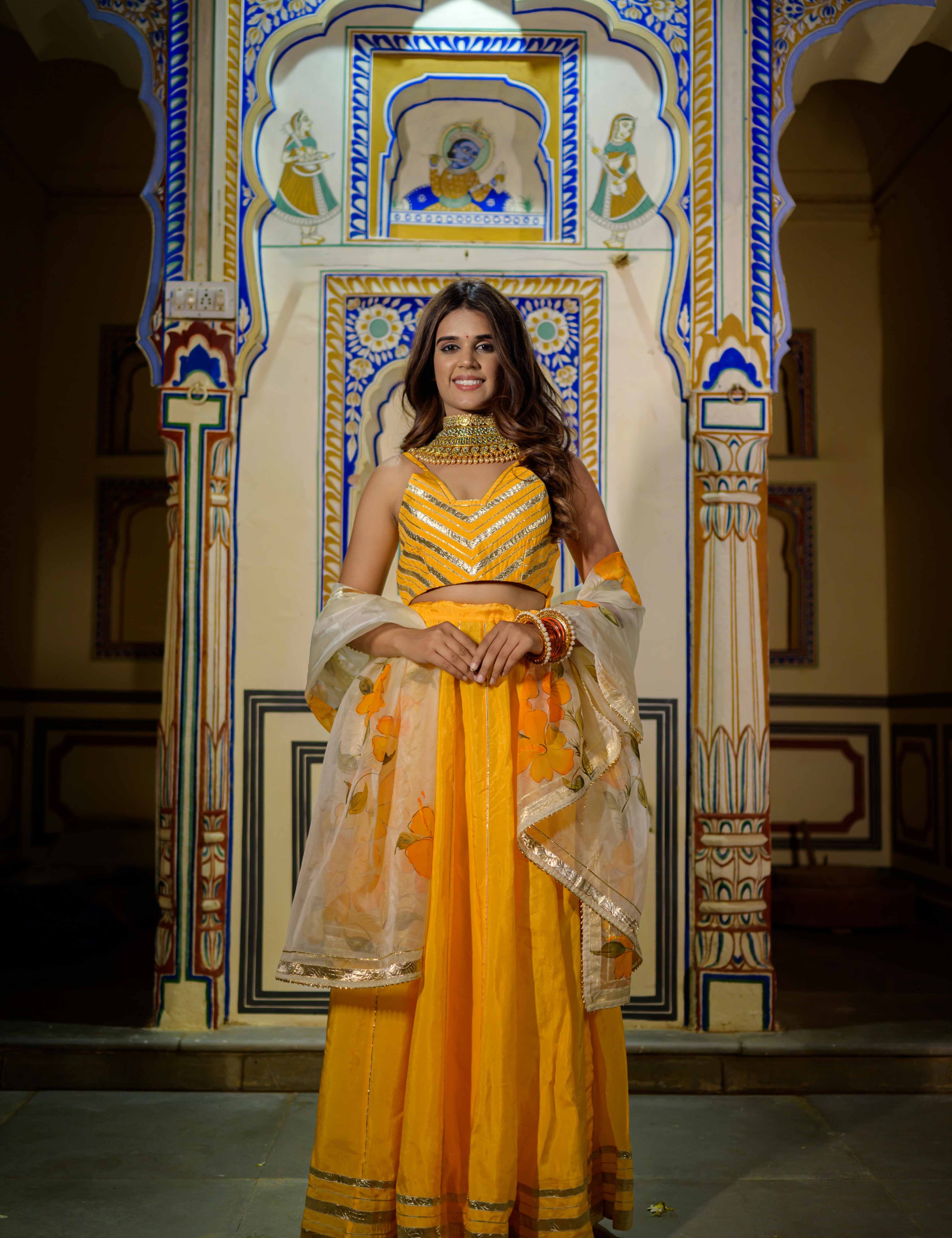 Front view of orange satin lehenga with gota work and net dupatta

