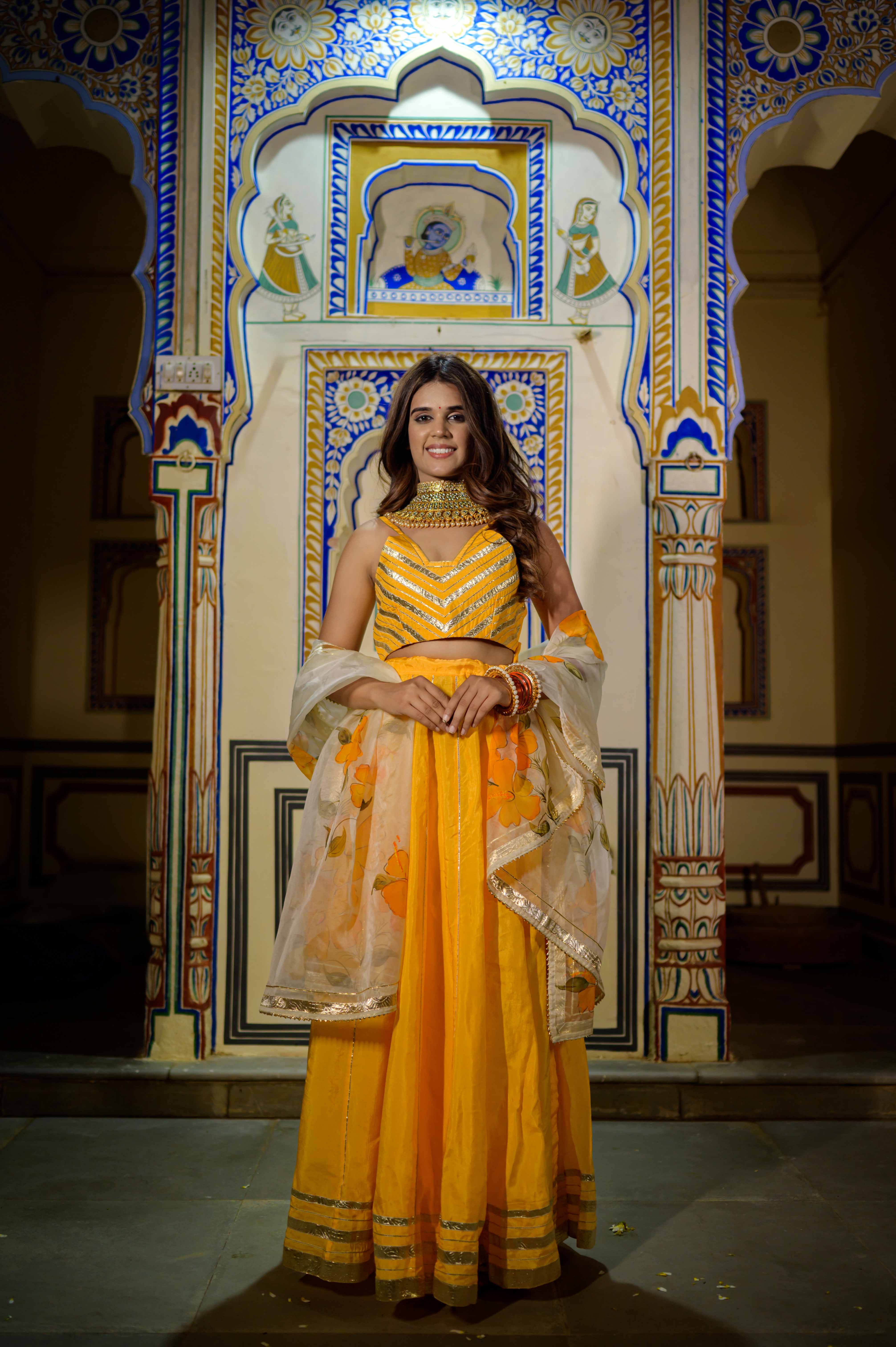 Front view of orange satin lehenga with gota work and net dupatta

