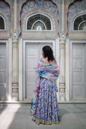 "Close-up of hand-painted blouse with delicate gota work on pastel satin fabric

