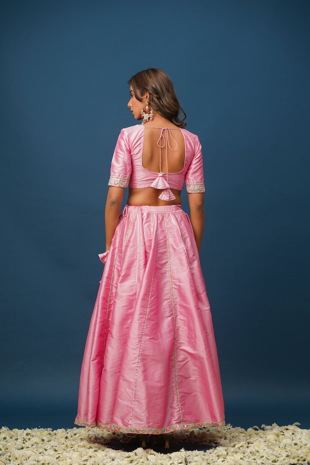 Pink lehenga paired with kundan jewelry and gold heels
