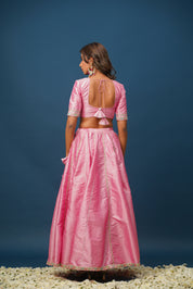 Pink lehenga paired with kundan jewelry and gold heels
