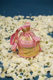 Flatlay of pink lehenga showcasing hand-painted florals