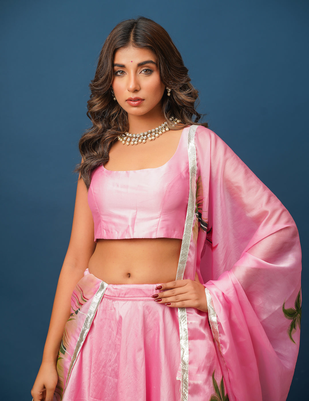 Elegant pink satin lehenga with organza dupatta styled for festive Indian celebration

