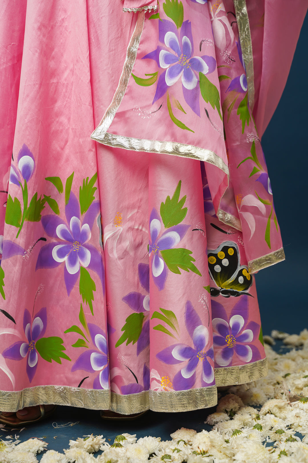 Close-up of floral painting on lehenga skirt
