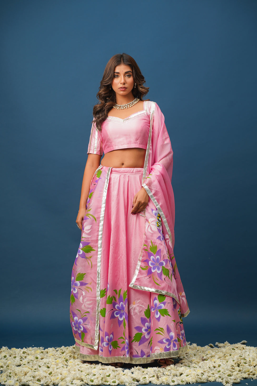 Flowing lehenga skirt in blush pink with intricate handwork
