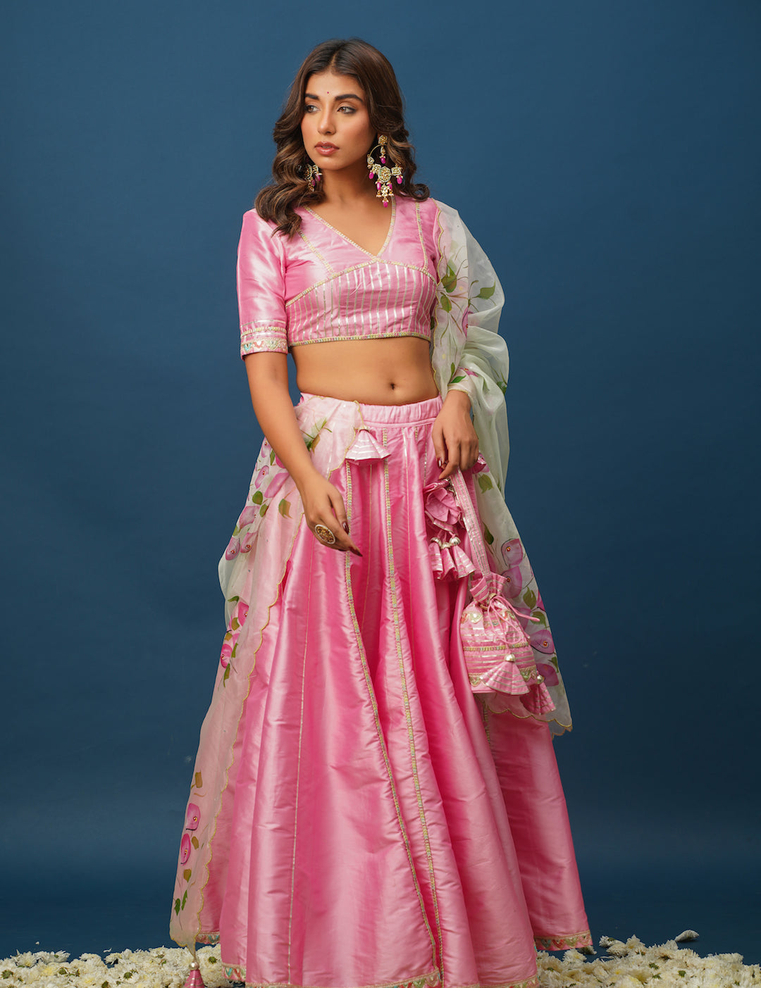 Close-up of designer pink lehenga with gota work and satin texture
