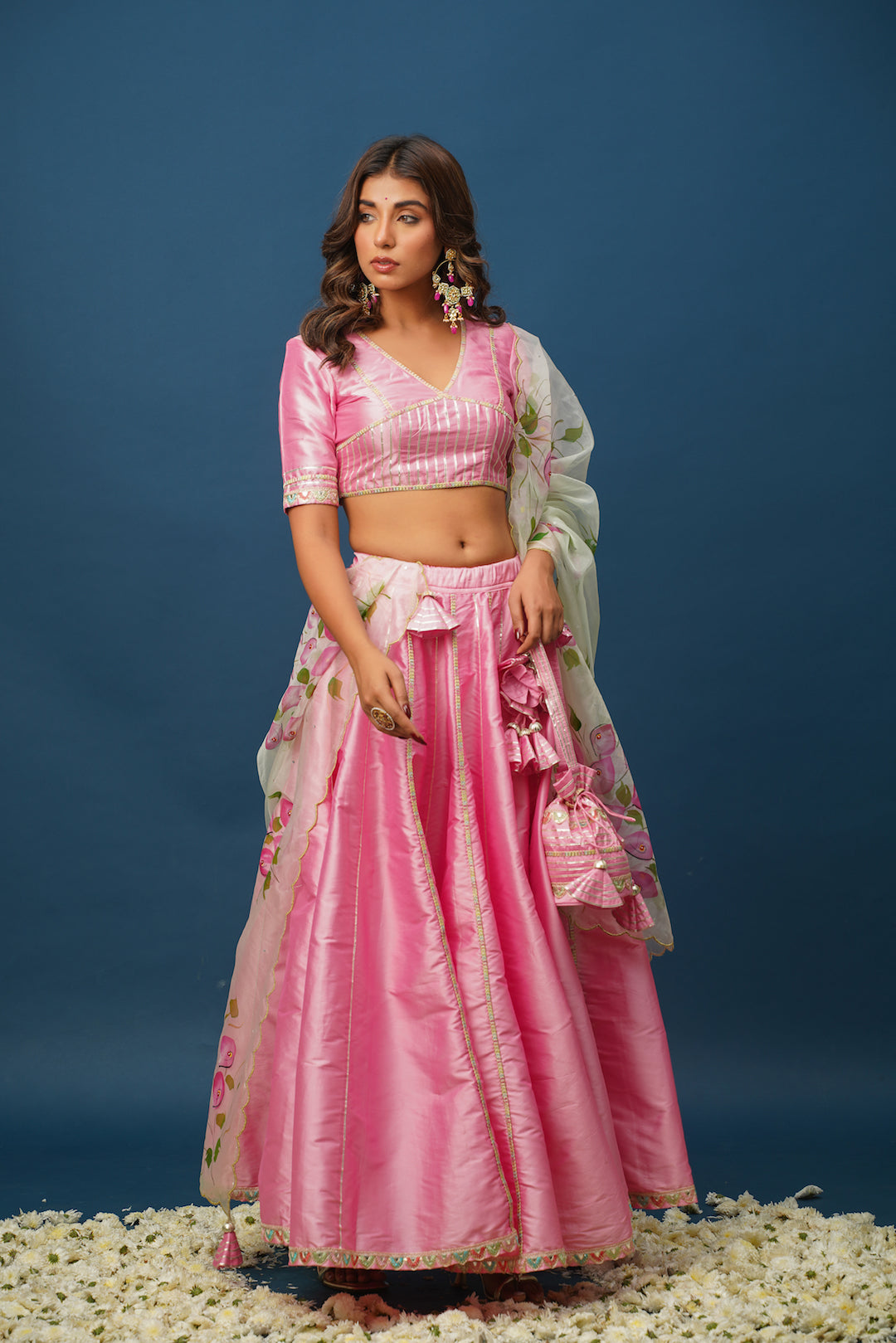 Close-up of designer pink lehenga with gota work and satin texture
