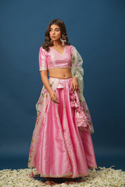 Close-up of designer pink lehenga with gota work and satin texture
