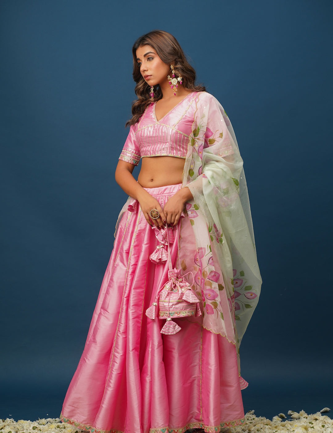 Woman wearing Rohini pink lehenga with floral hand-painting
