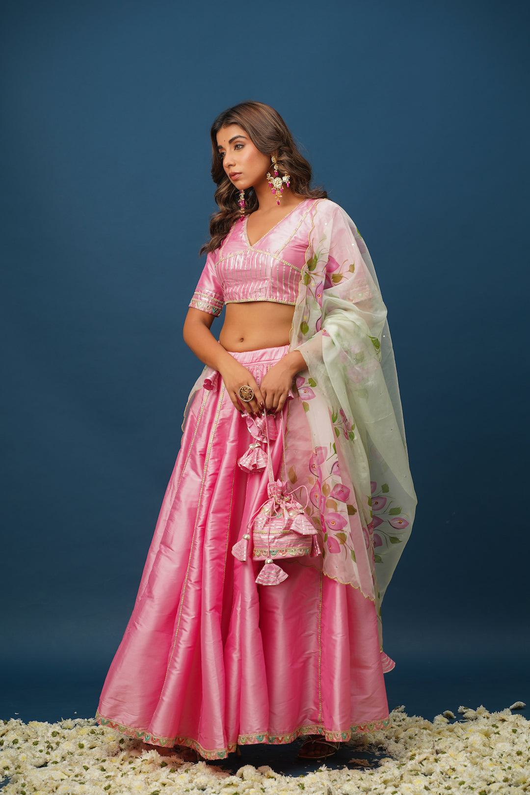 Woman wearing Rohini pink lehenga with floral hand-painting
