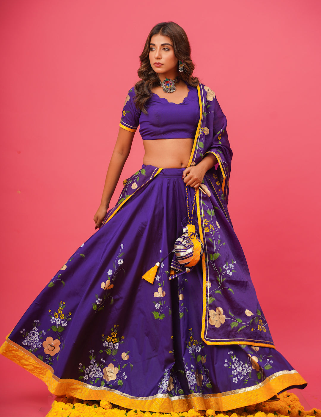 Elegant violet lehenga set with gota work styled for festive occasions
