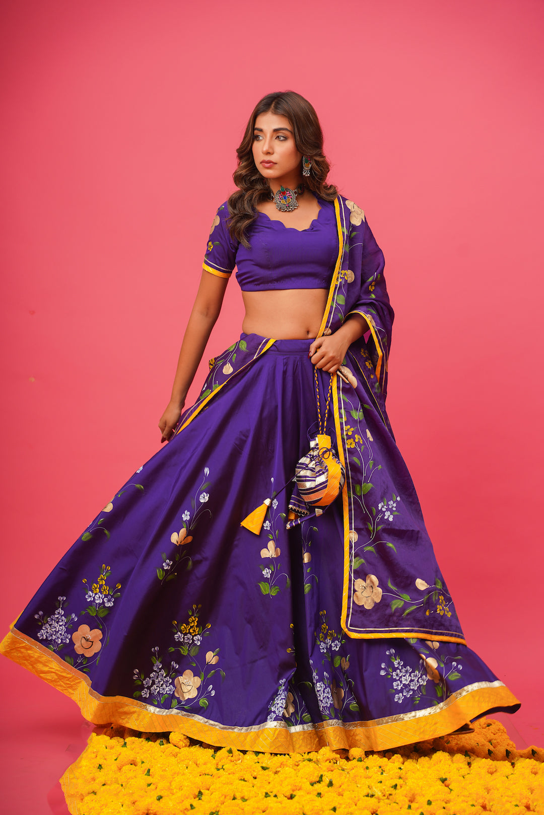 Elegant violet lehenga set with gota work styled for festive occasions
