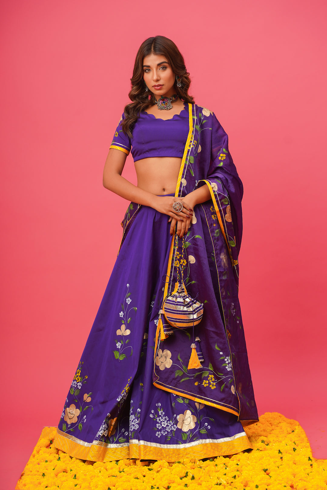 Model wearing violet silk lehenga with hand-painted floral motifs and organza dupatta

