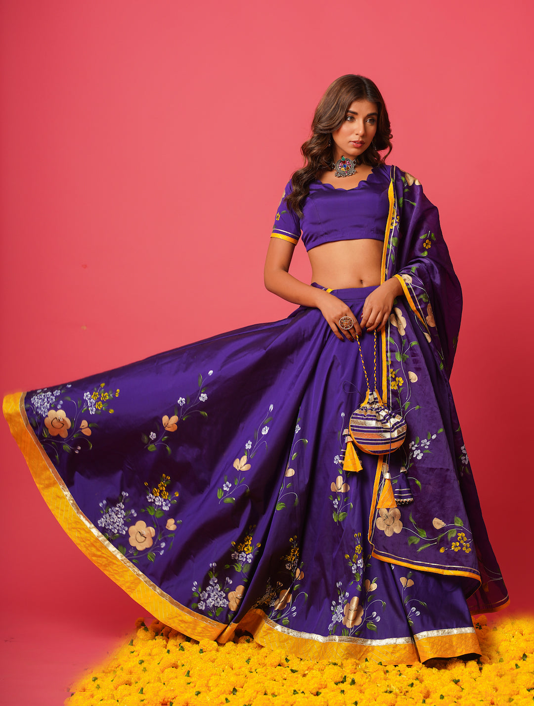 Side pose of woman in traditional violet lehenga for weddings and receptions
