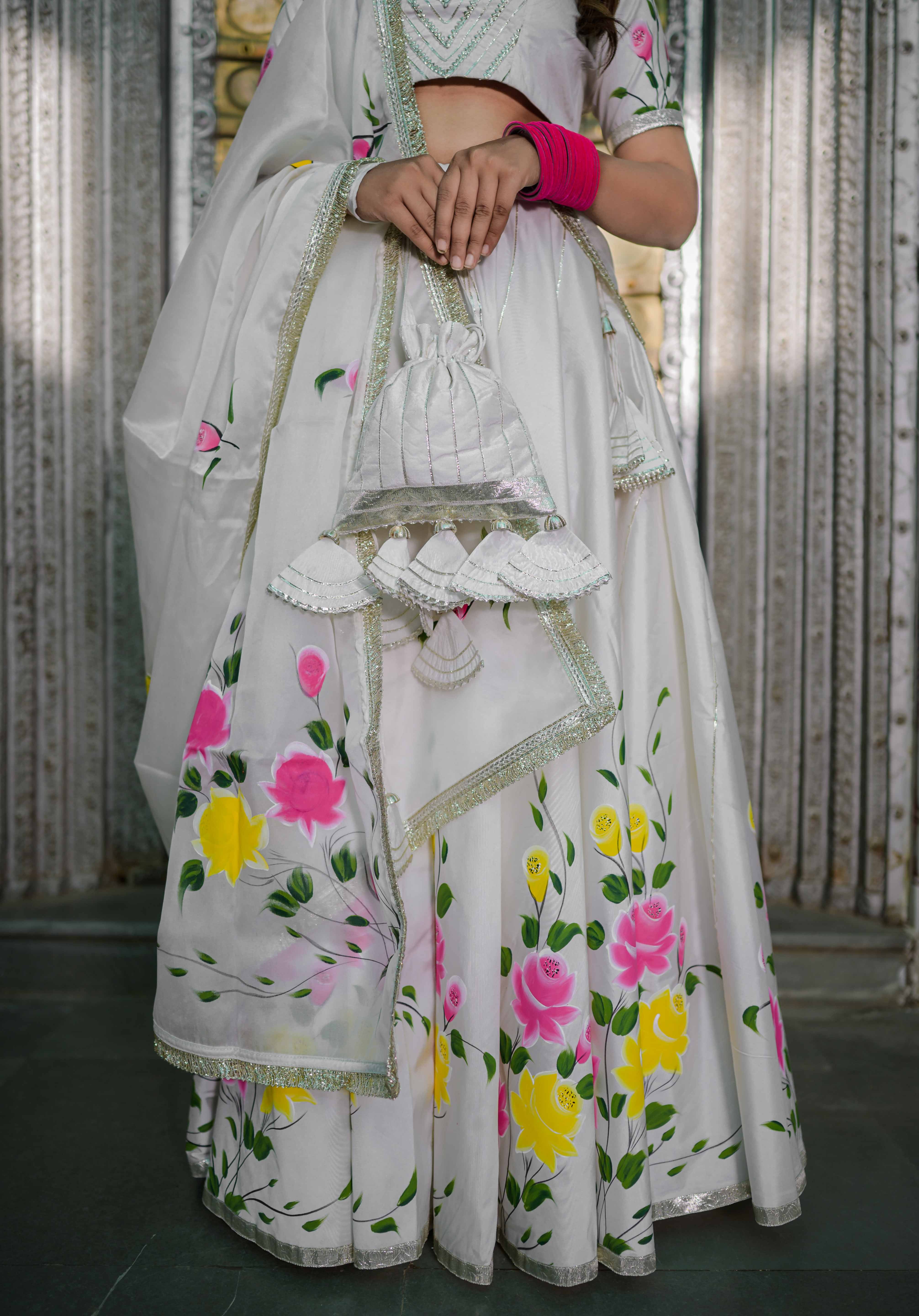 Back view of handcrafted white lehenga with blouse and dupatta

