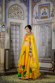 Golden organza dupatta detail against satin yellow fabric

