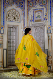 Close-up of yellow lehenga blouse with golden embroidery

