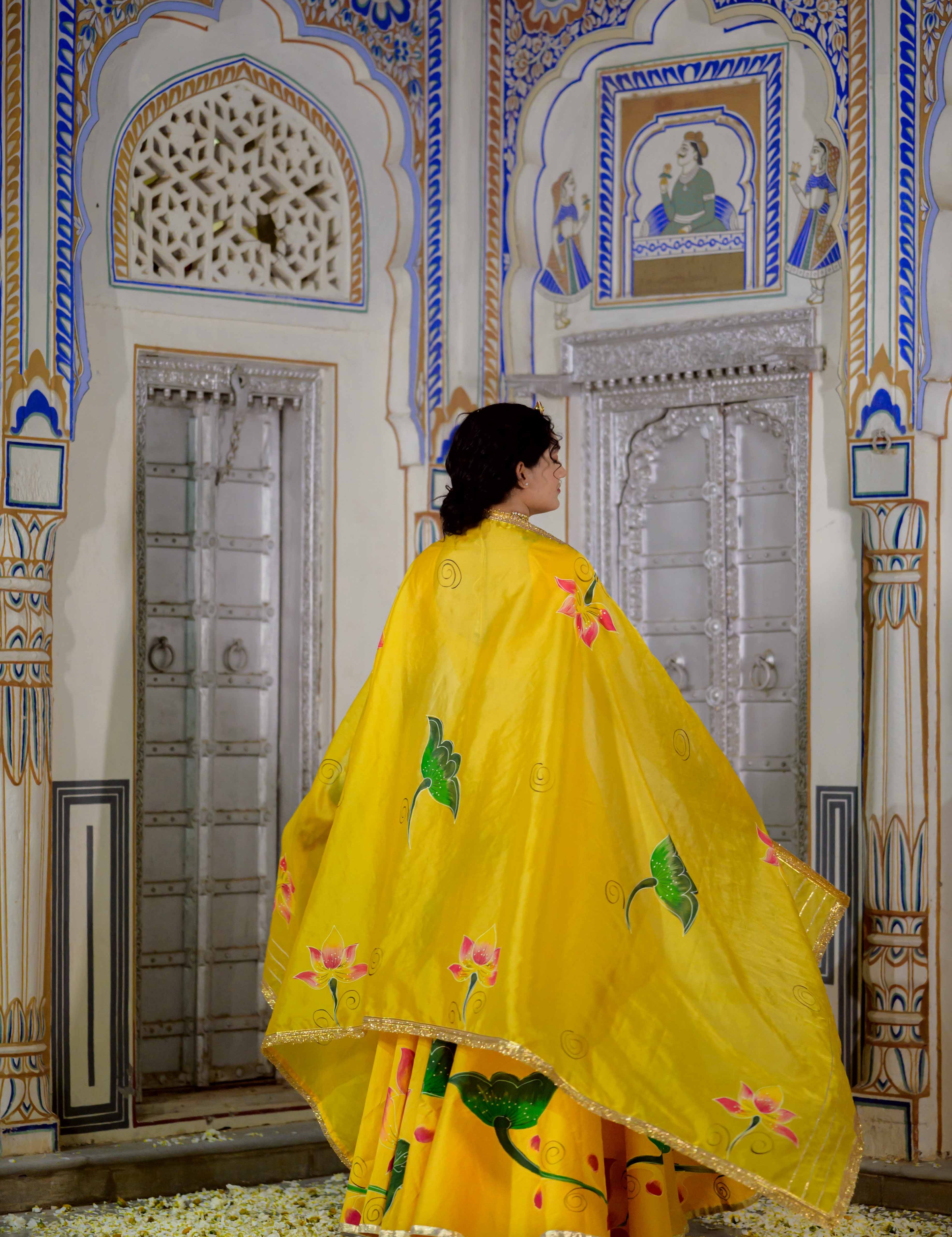 Close-up of yellow lehenga blouse with golden embroidery

