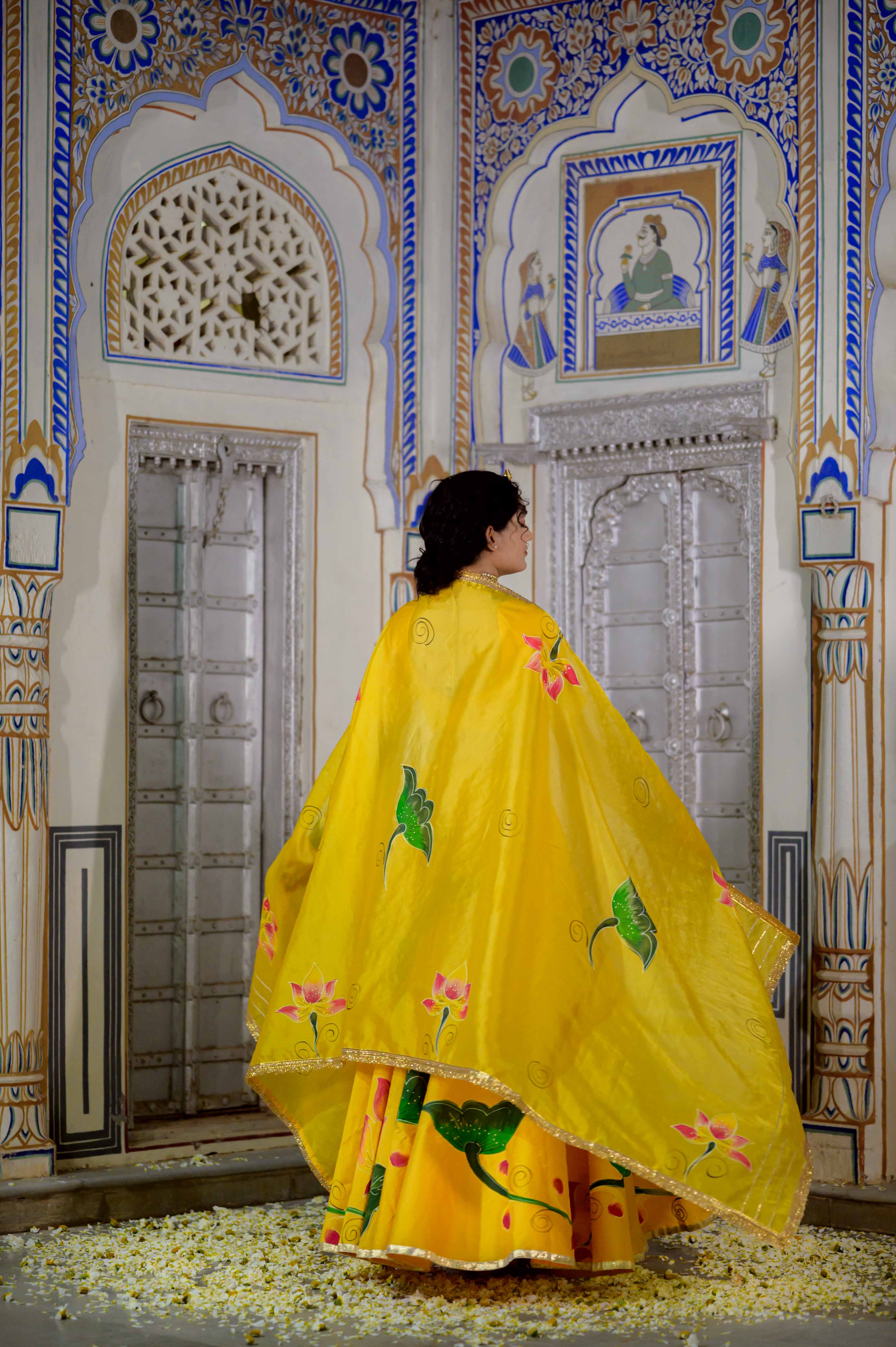 Close-up of yellow lehenga blouse with golden embroidery

