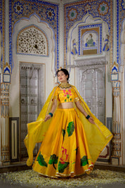 Full yellow lehenga set with blouse, skirt, and dupatta flat-laid

